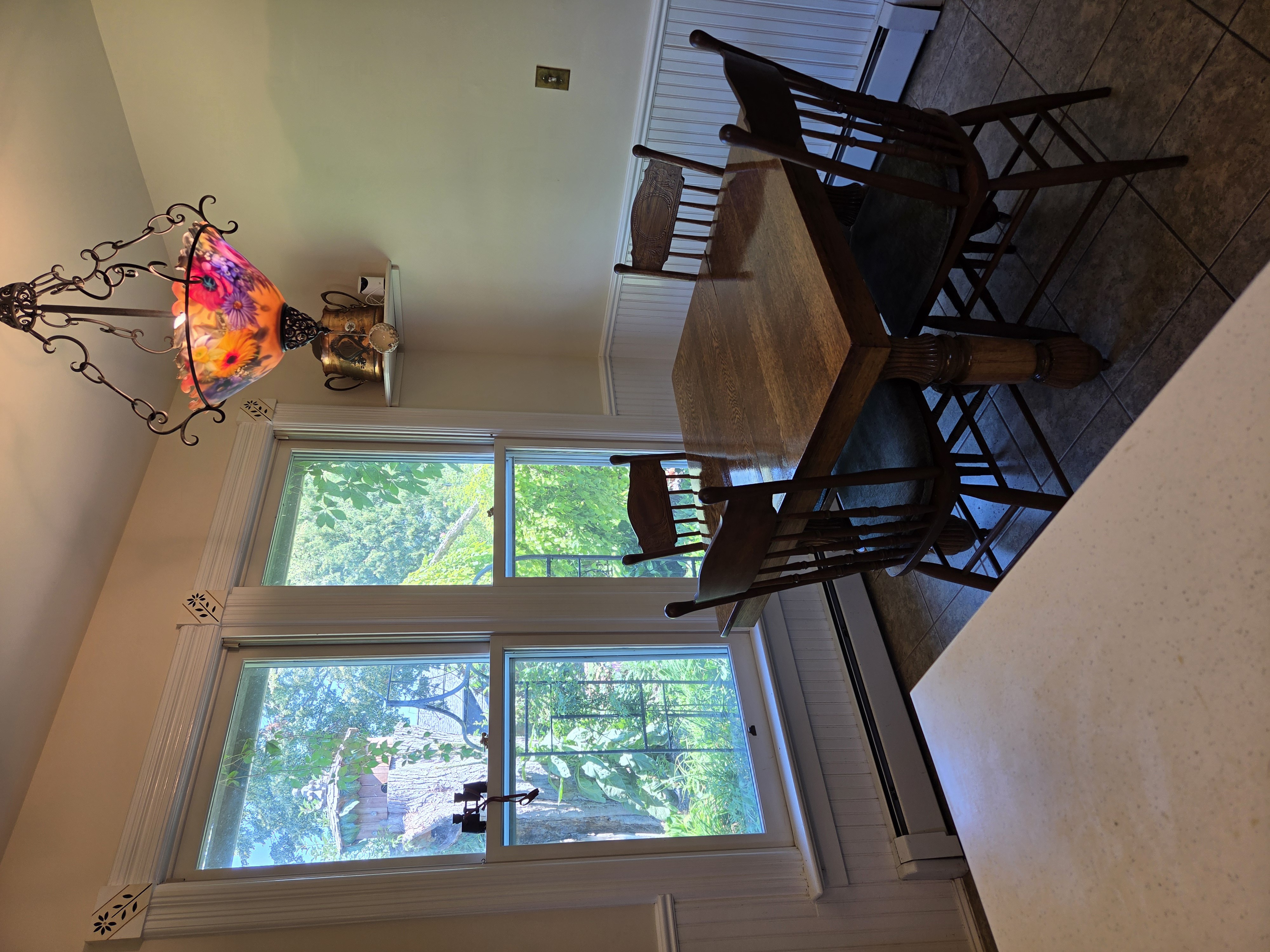 Breakfast nook with stained glass chandelier and garden views